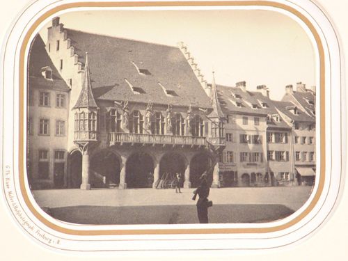 View across square to town hall, with armed guard in foreground, Freiburg im Breisgau, Germany