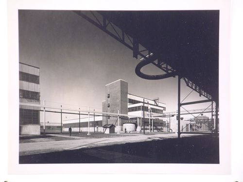 View of the principal and lateral façades of the Coagulation Building with a warehouse in the background, B.F. Goodrich Company Geon Plant, Louisville, Kentucky