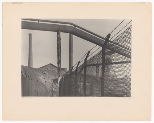 Detail of fence and chimney at industrial site, Ruhr district, Germany