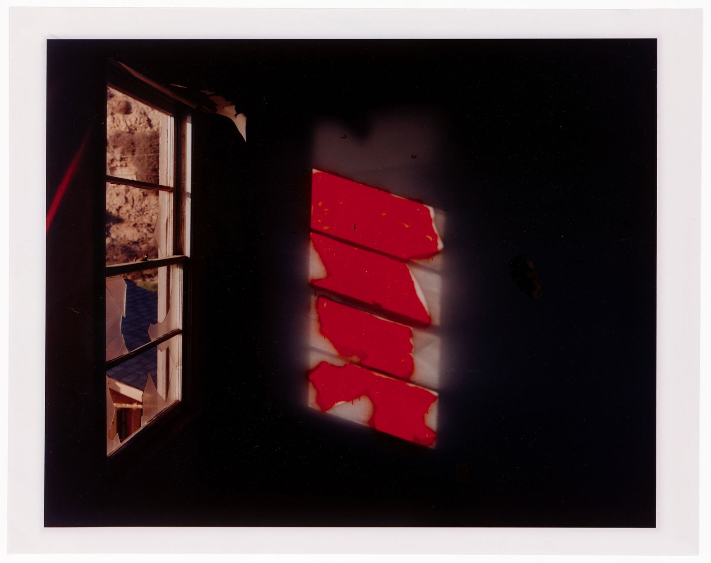 Abandoned beach house, broken window and reflection on red graffitti, California ?