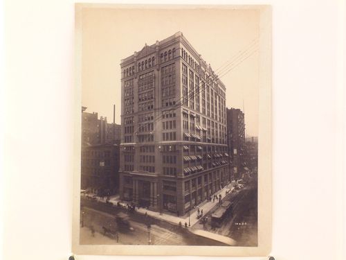 Large office [?] building on street corner with window-washers working outside, Chicago, Illinois
