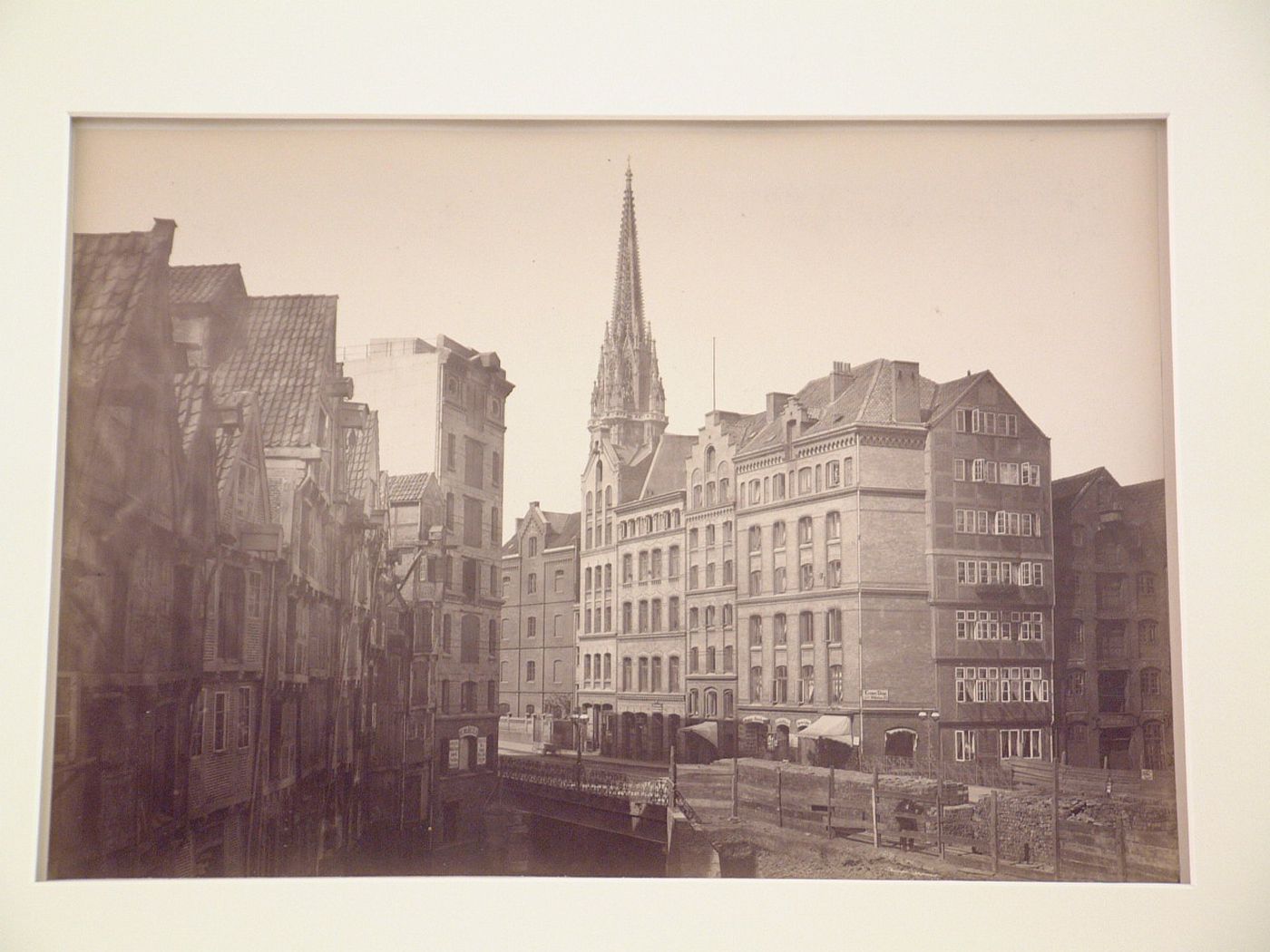 View of residential street looking towards tower spire of church of Saint Nicholas, Hamburg, Germany