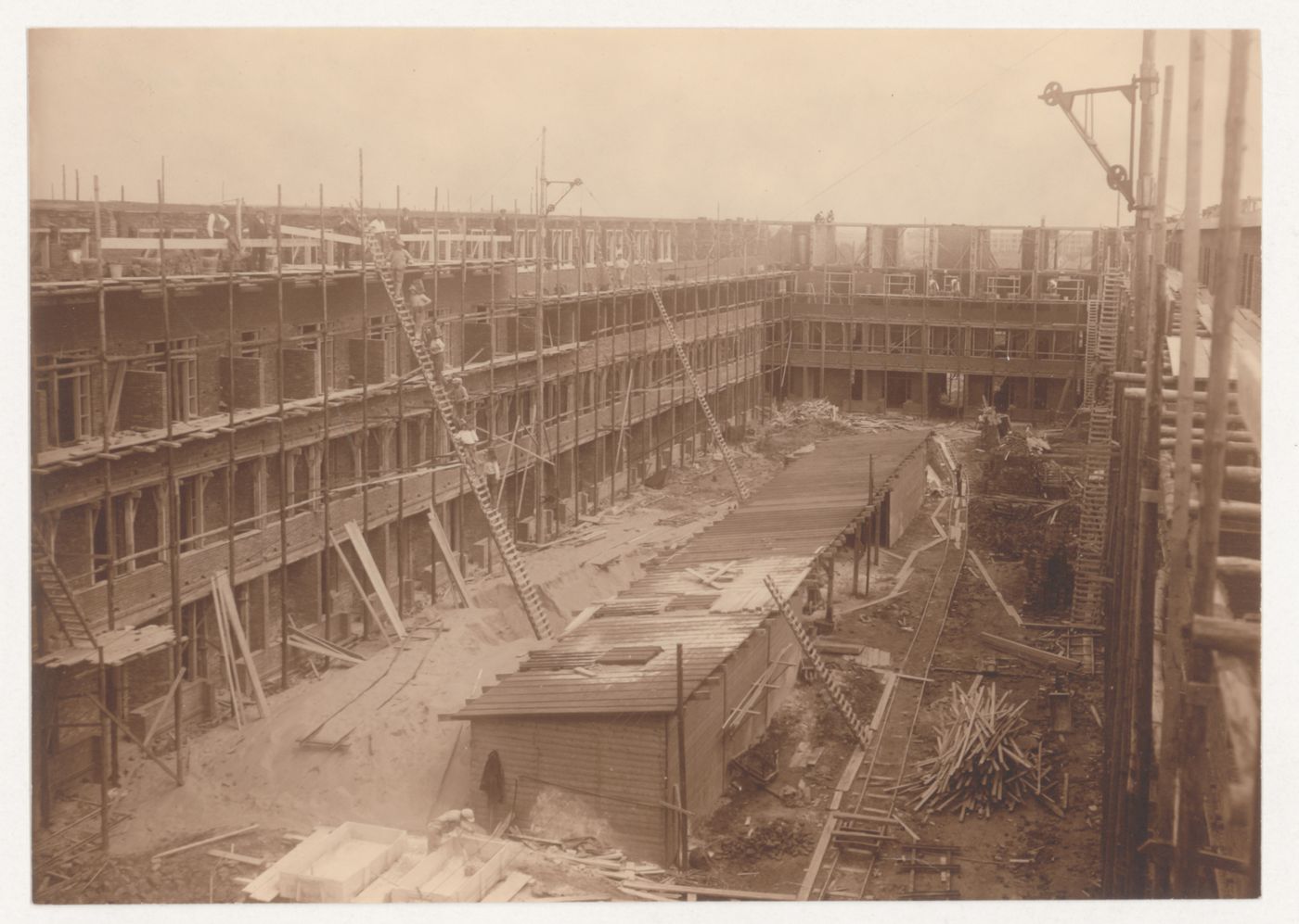 Exterior view of Tusschendijken Housing Estate showing a courtyard under construction, Rotterdam, Netherlands