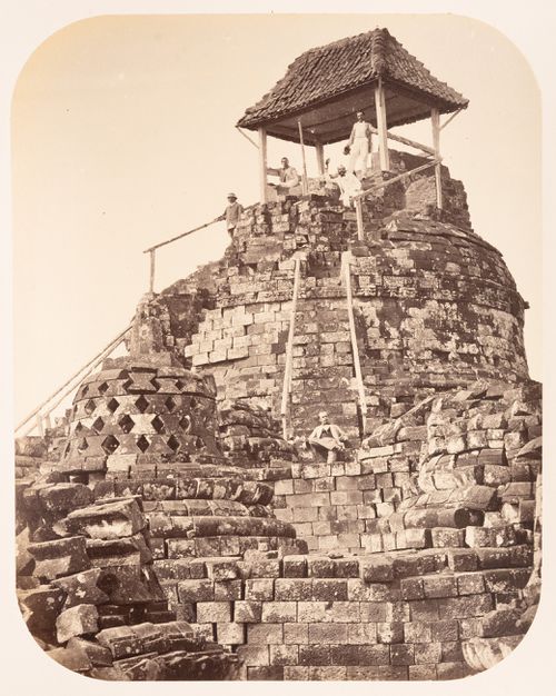 Group portrait of men on the central stupa, Borobudur, Dutch East Indies (now Indonesia)