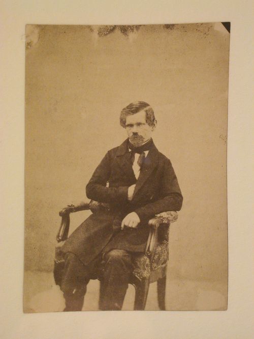Portrait of a man seated in an armchair