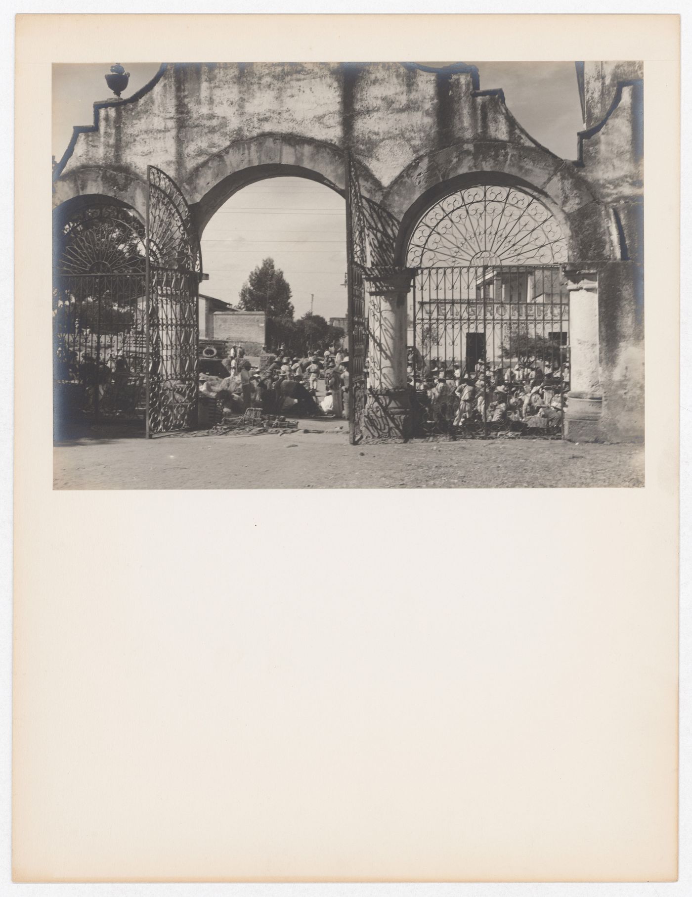 View of a churchyard gate and people, Metepec, Mexico