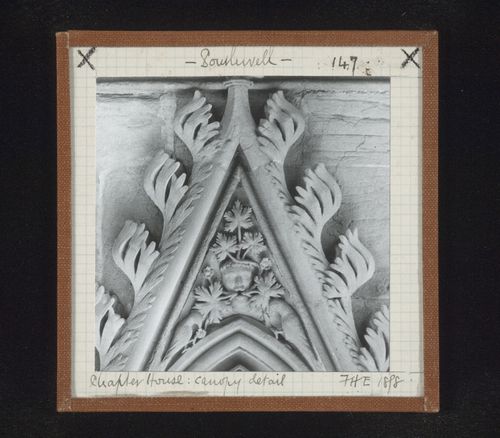 Detail view of canopy with foliate mask and two birds on tympanum in Chapter House, Southwell Minster, Southwell, Nottinghamshire, England