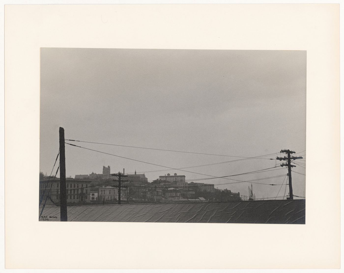 Telegraph poles and roof in foreground with buildings in distance (No. 9), Staten Island, New York City, New York