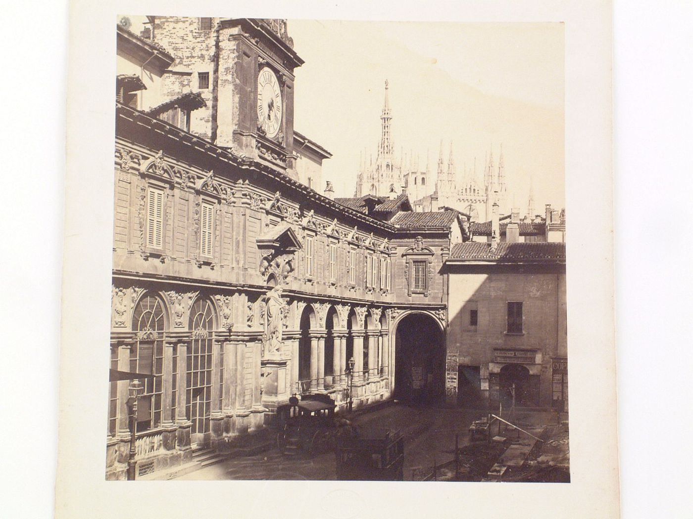 Piazza degli Mercanti with carriages and large clock on left, Milan, Italy