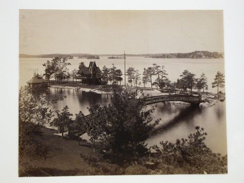 View of woodbridge and Gothic Revival House with two-tiered, wraparound porch, at the Thousand Islands, New York
