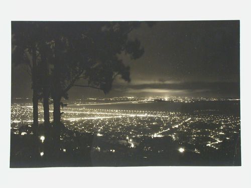 Night view of the East Bay crossing between Yerba Buena Island and Oakland showing the San Francisco-Oakland Bay Bridge, Berkeley, Oakland, and San Francisco, California