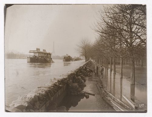 Construction of the Paris Metro, exterior view of sandbags lining the flooded riverbanks of the Seine, Eiffel Tower in background, Paris, France