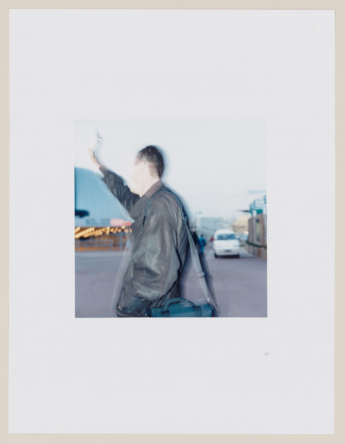 Portrait of a man showing a street and buildings in the background, Futuroscope amusement park, Poitiers, France (from the series "In between cities")