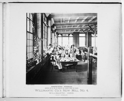 Interior view of women around a table to inspect threat, and a man watering plants, Willimantic Company’s new mill, no. 4, town of Willimantic, now Windham, Connecticut, United States