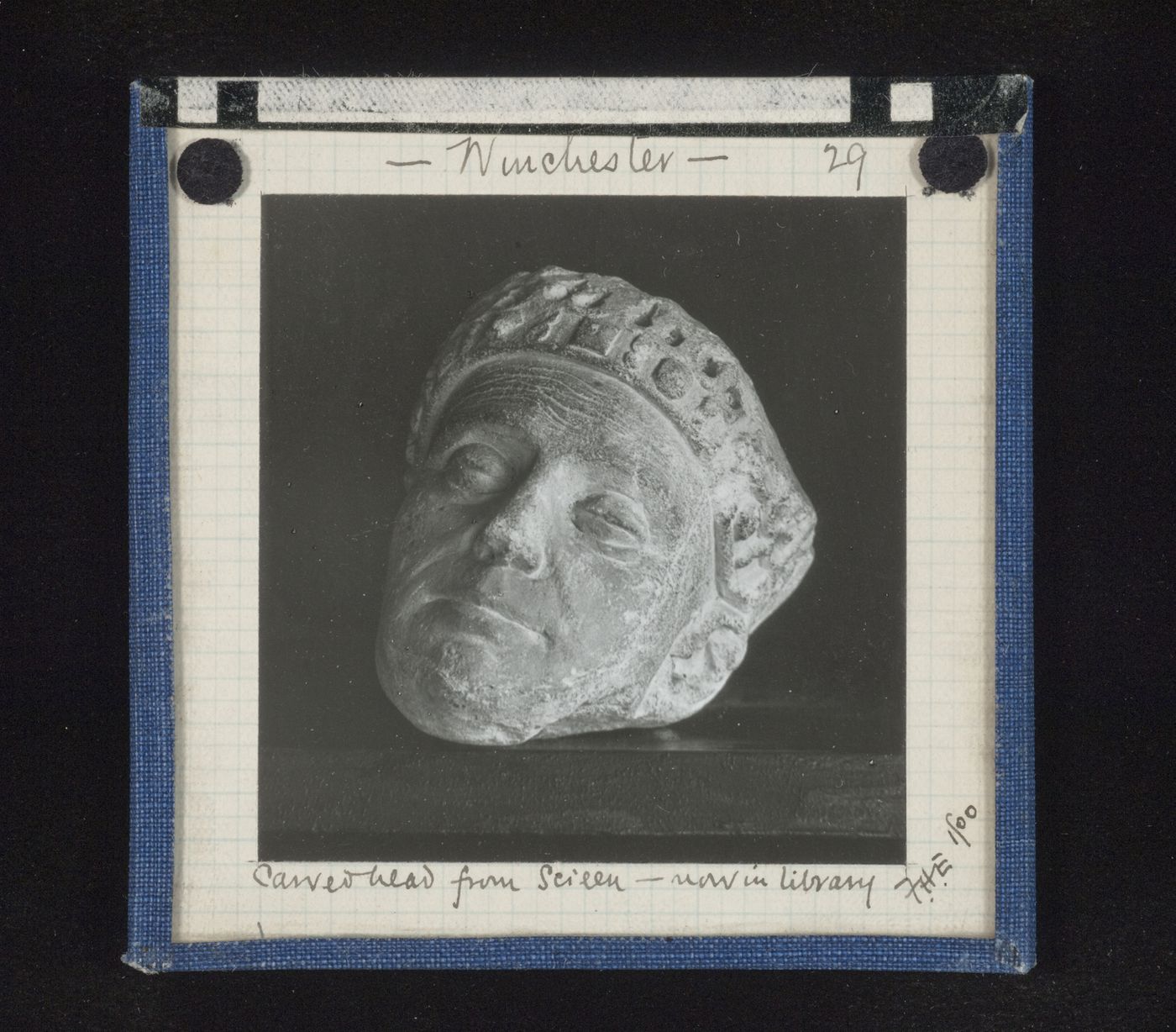 View of sculpture of head in library, sculpture originally from screen, Winchester Cathedral, Winchester, Hampshire, England