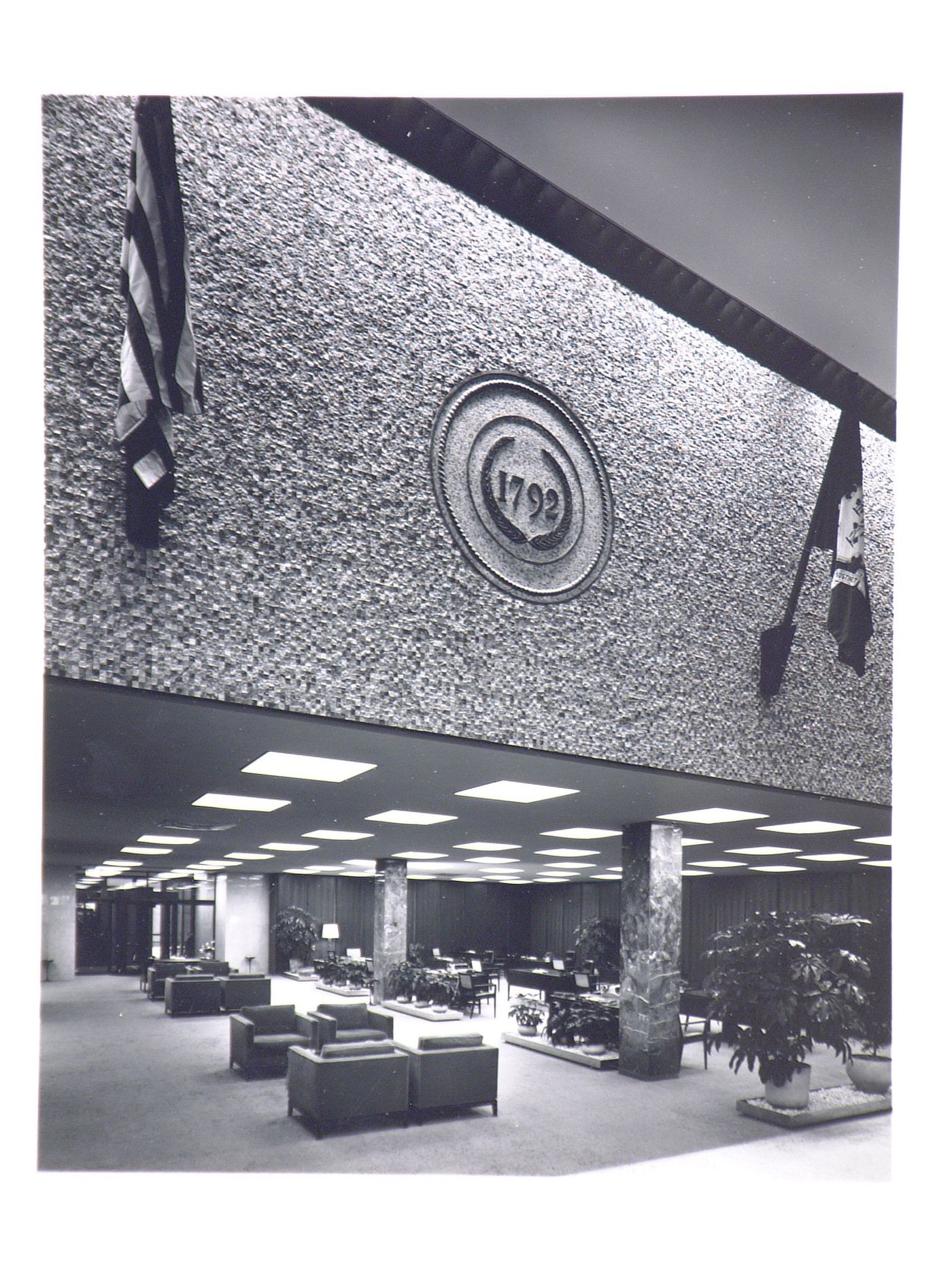 Interior view of the customer waiting and transaction area with two flags and a 1792 sign on the ground floor of the Hartford National Bank and Trust Company building, Hartford, Connecticut, United States