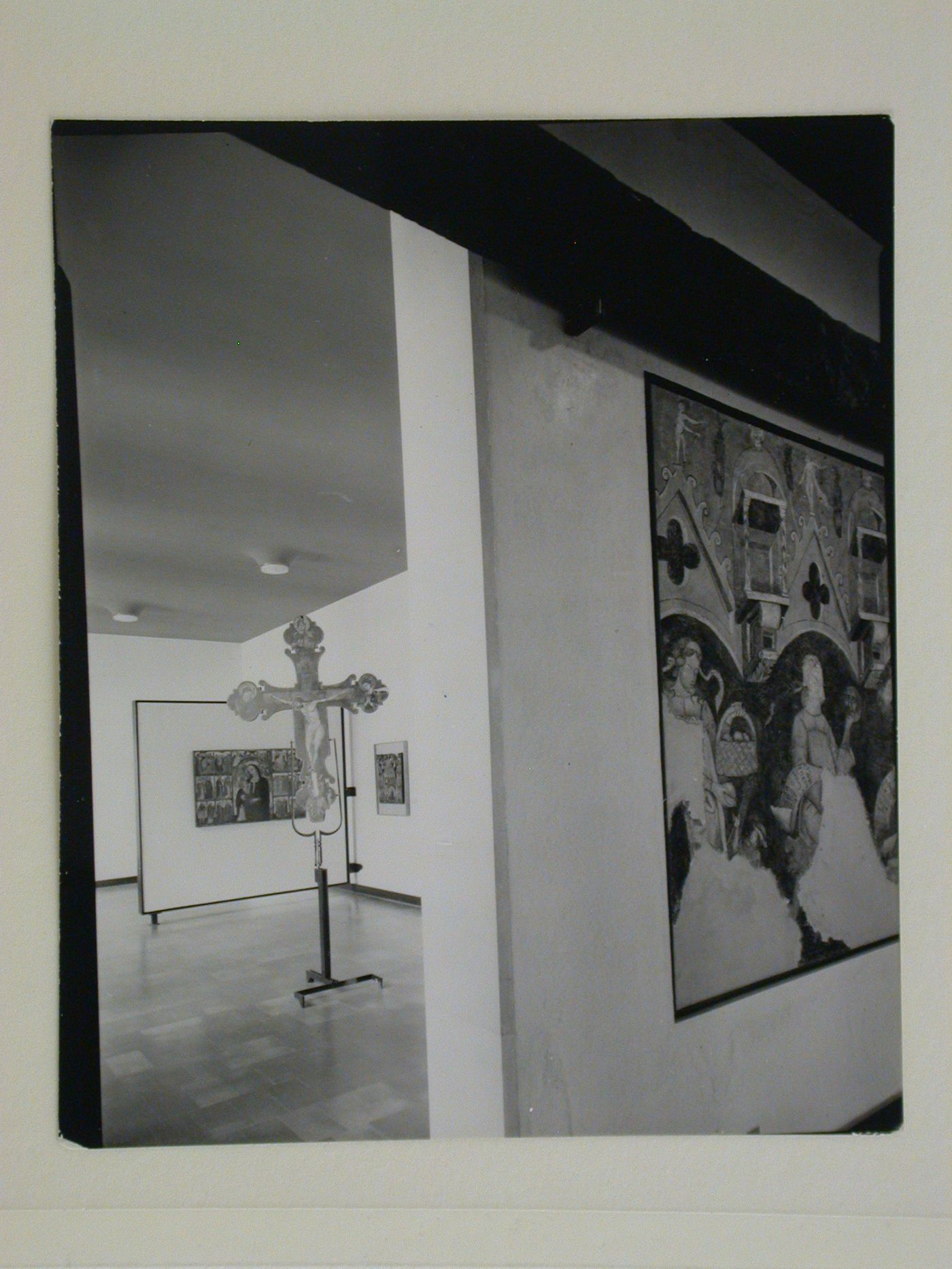Interior view of a galleries showing paintings and a freestanding painted crucifix, Museo Correr, Venice, Italy