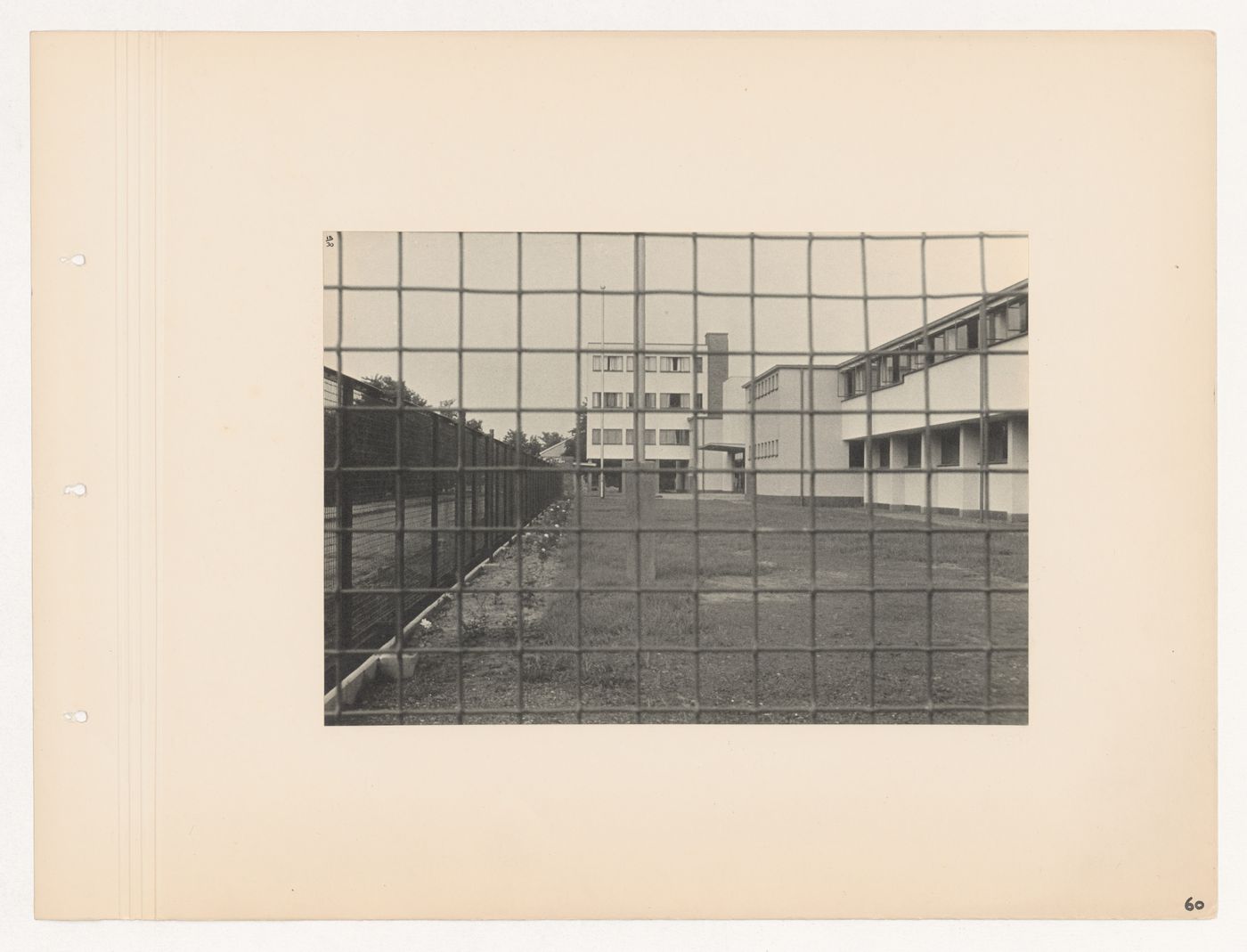 View of the main entrance and employees' building of the Budge Foundation Old People's Home through a chain link fence, Frankfurt am Main, Germany