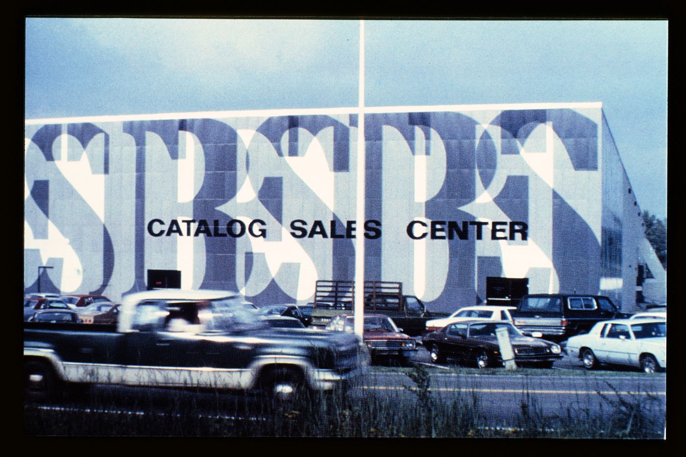Slide of a photograph of BEST Products Anti-Sign Showroom, Ashland, by James Wines / Sculpture in the Environment (SITE)