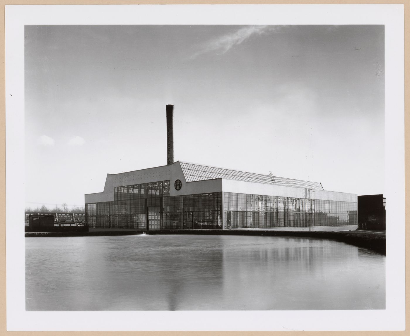 General view of the principal [?] and lateral façades of the Roll and Heavy Machine Shop from across a river [?], Ohio Steel Foundry, Lima, Ohio