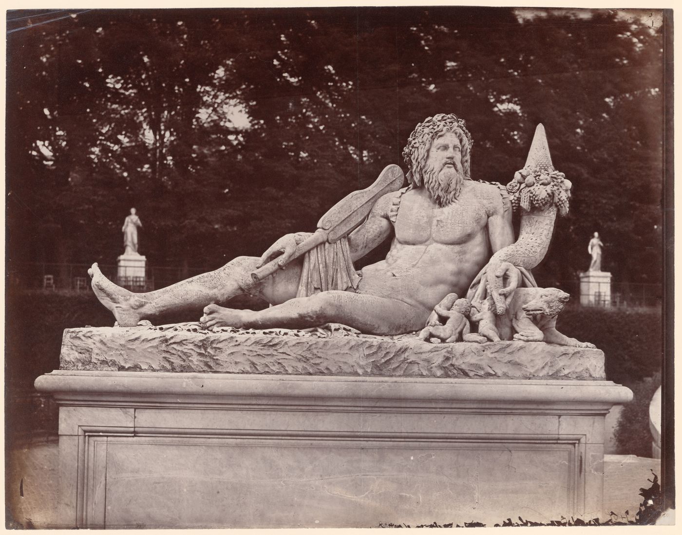 Tuileries Gardens, view of a reclining male god, carved in stone, Paris, France
