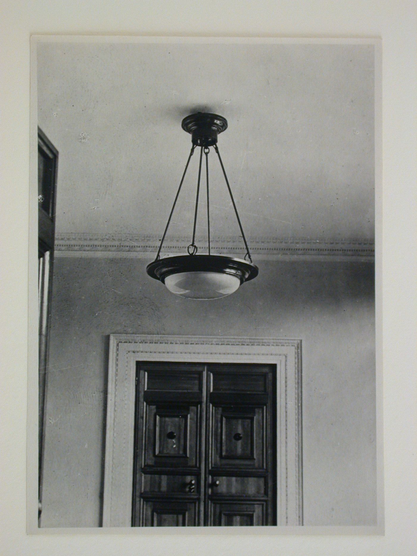 Interior view of an apartment showing a ceiling, chandelier and door, 16 Mokhovaia Street, Moscow