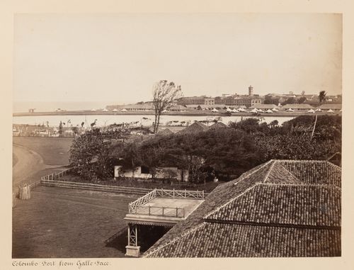 View of Colombo Fort from Galle Face with the Galle Face Burial Grounds on the left and the clock tower and lighthouse in the background, Colombo, Ceylon (now Sri Lanka)