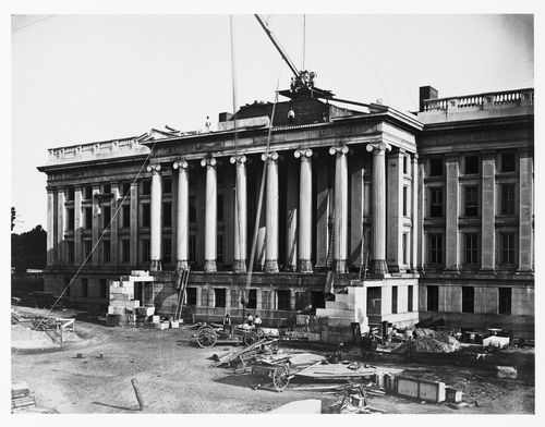 Treasury Building under contruction: Workmen operating crane, hoisting wagon, Washington, District of Columbia