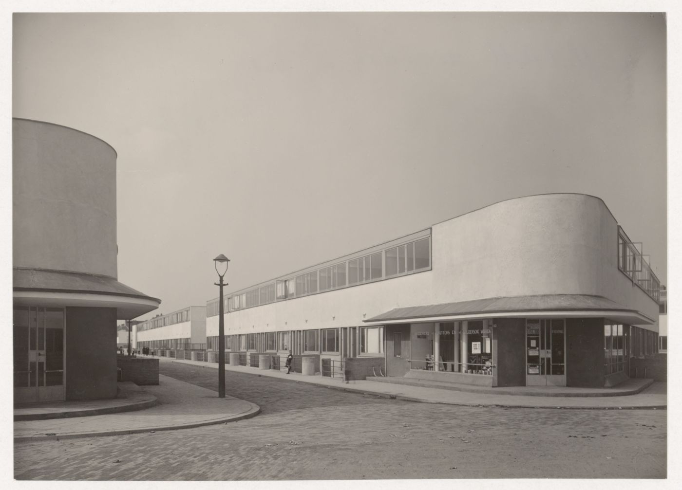 View of the principal façade of Kiefhoek Housing Estate showing a corner store from across the street, Rotterdam, Netherlands