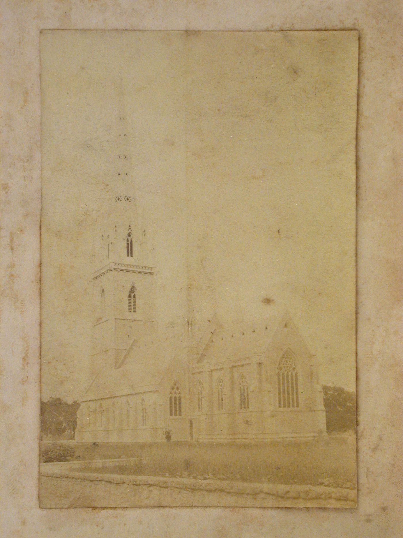 Rear view of a church showing the apse, an outer aisle and the church tower, England