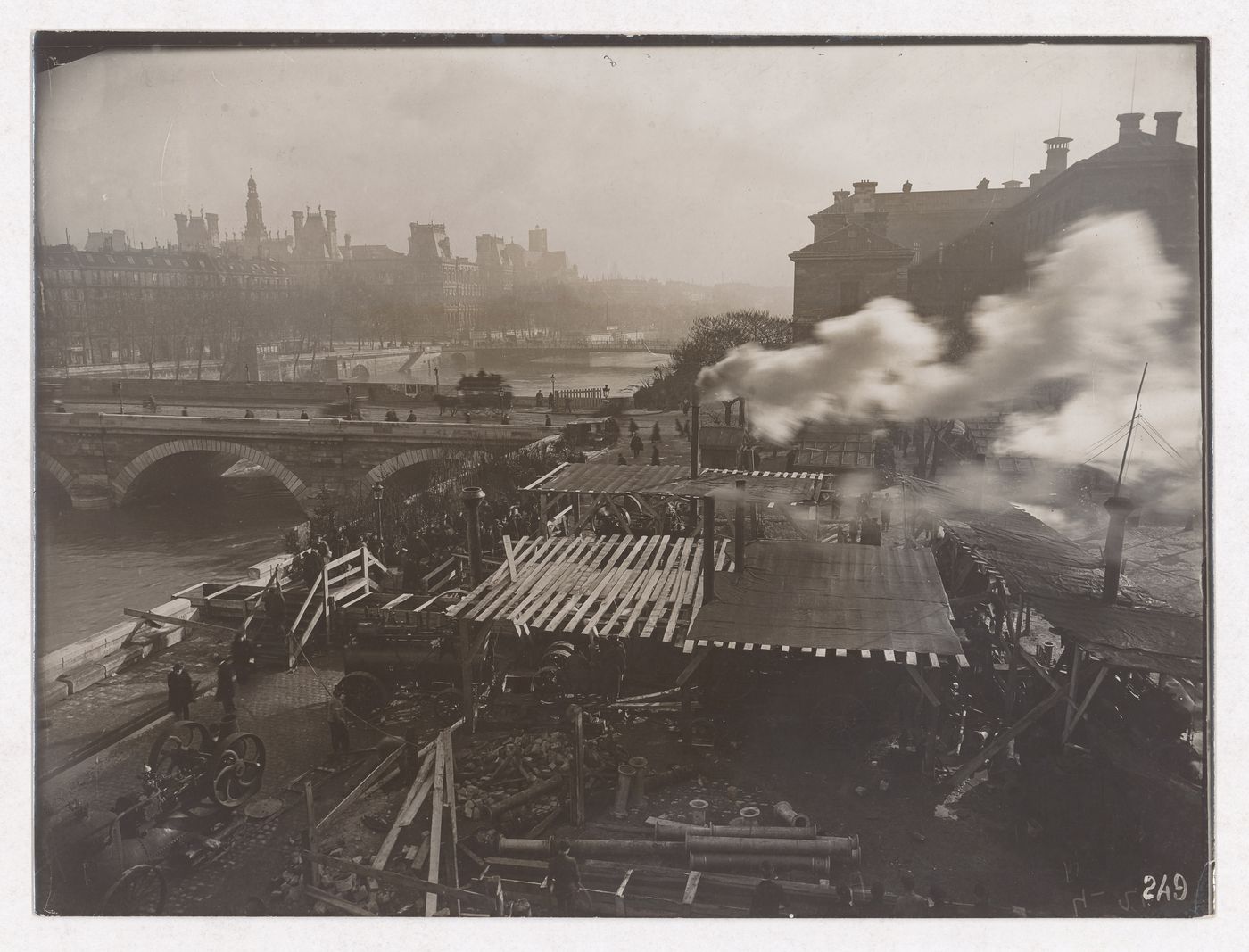 Construction of the Paris Metro, exterior view with machinery, workers and smoke coming out of smoke stacks, Paris, France