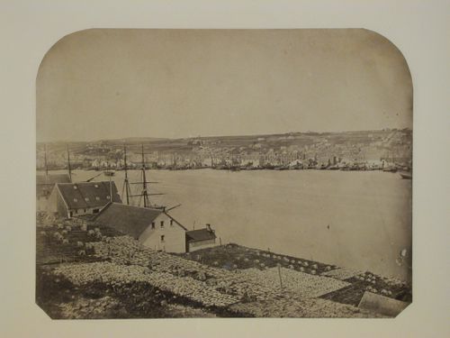 View of an inlet showing a port, buildings and fish drying racks