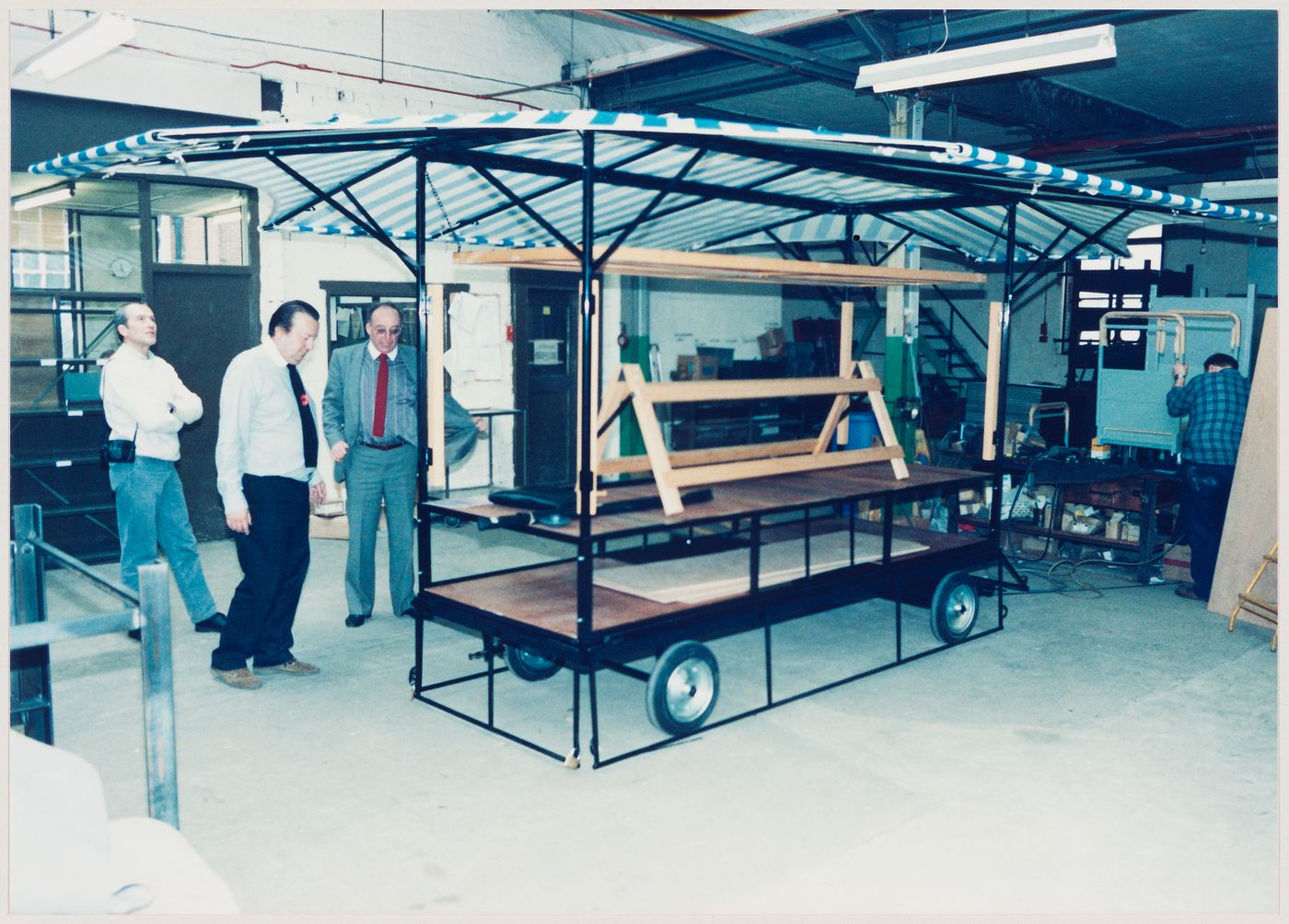 Westal: assembled market stall being inspected by Cedric Price (centre)