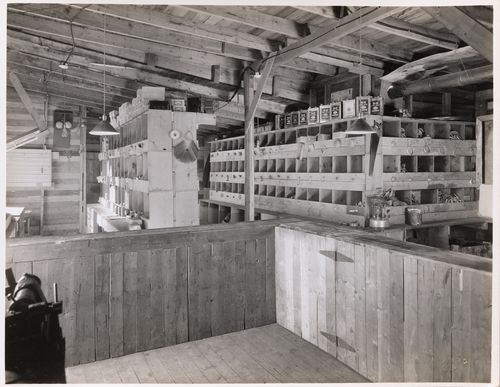 Interior view of a room showing open-fronted storage units for electrical [?] parts and supplies, Montréal [?], Québec