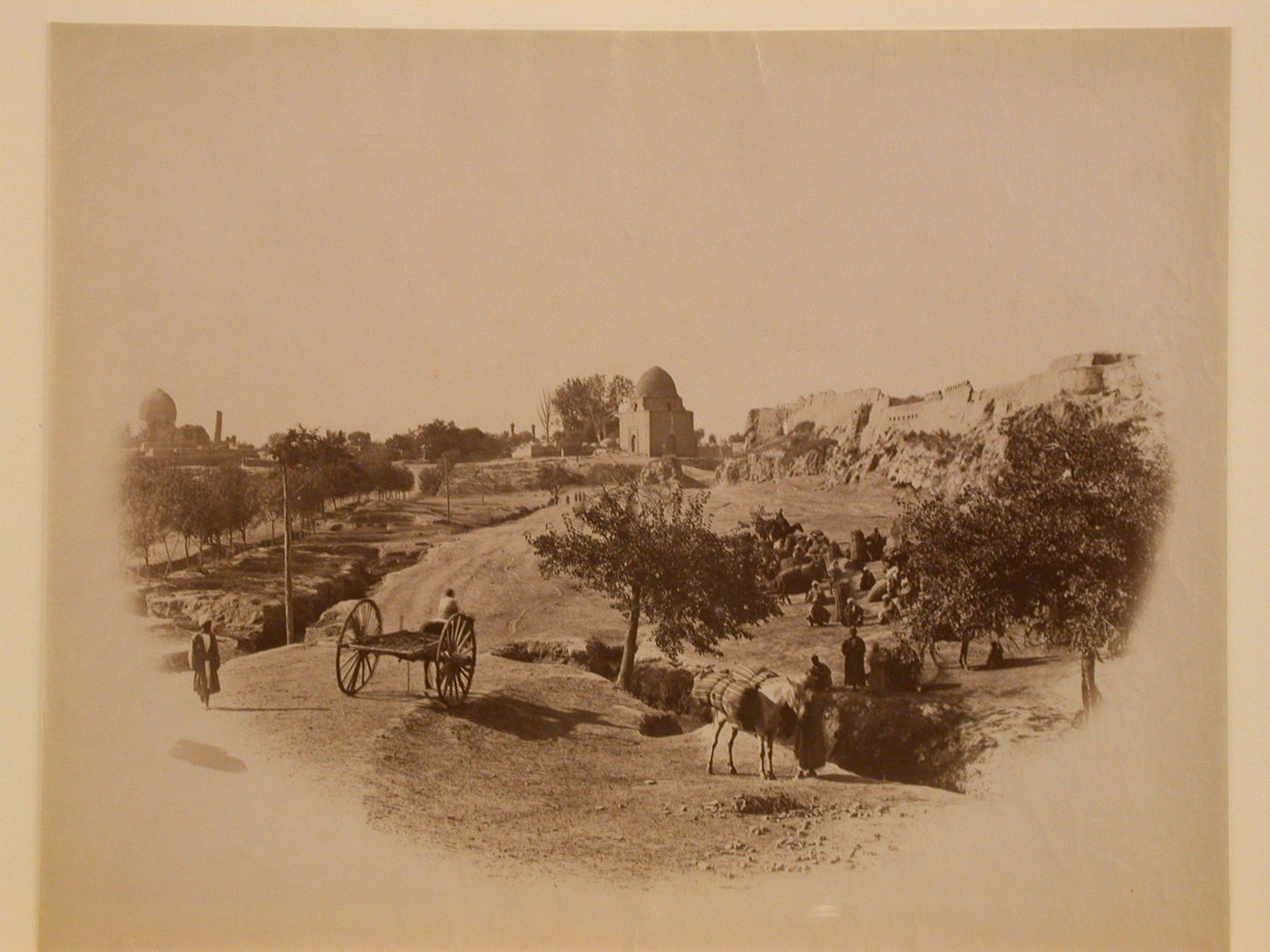 Rocky terrain with people and archaeological site in background, Uzbekistan, former Soviet Union