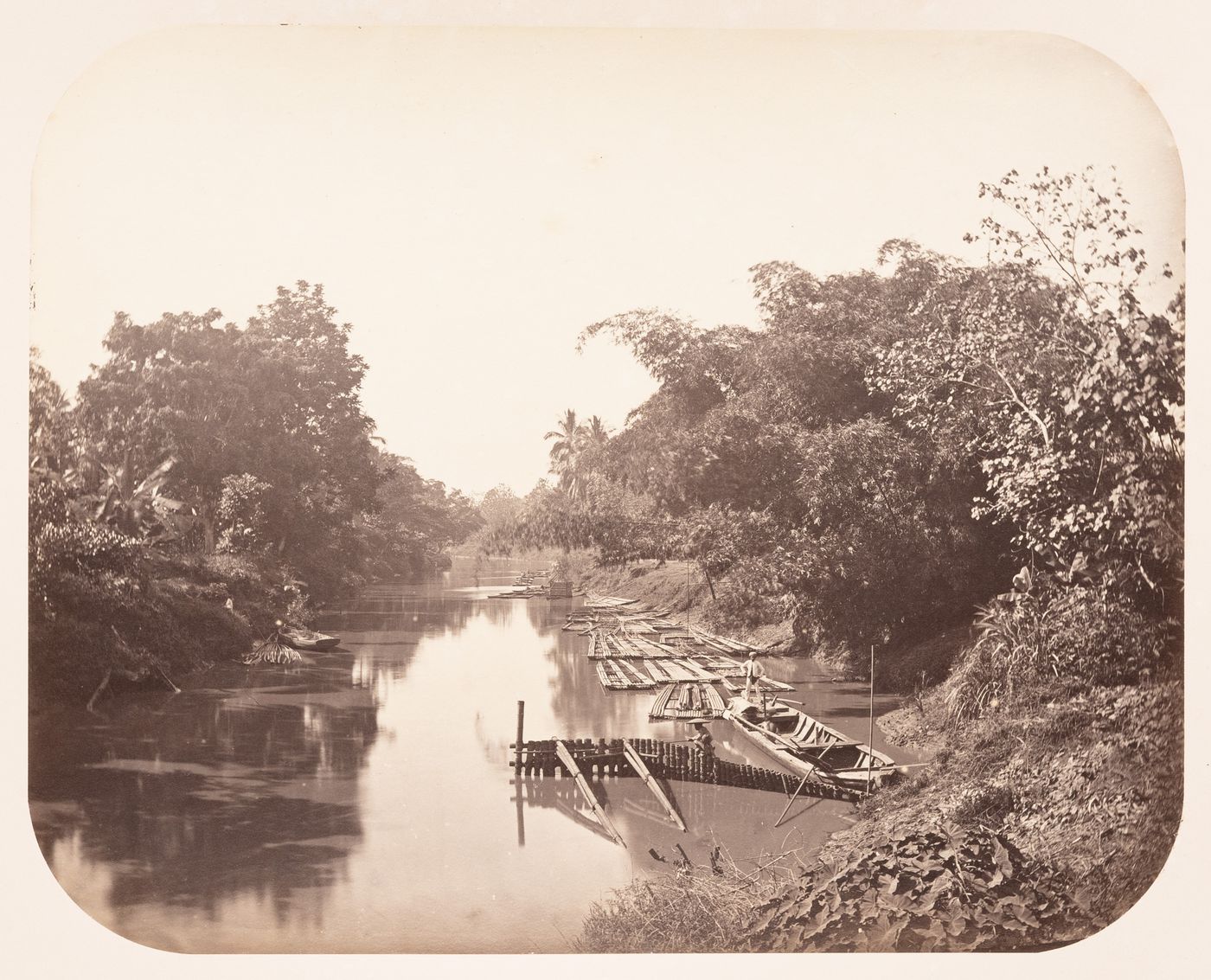 View of a river showing sampans and rafts, Dutch East Indies (now Indonesia)