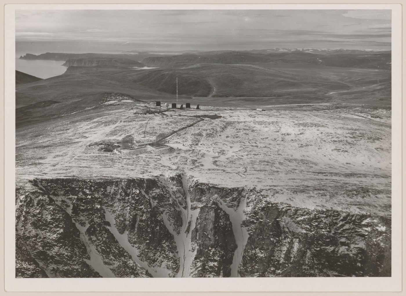 Aerial view of DEW Line radar station DYE-Main and DEW Drop troposcatter telecommunication system, Cape Dyer, Nunavut, Canada