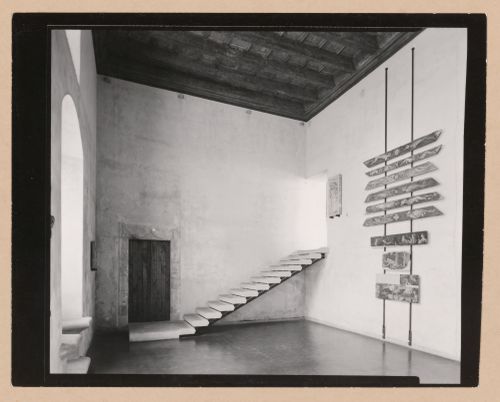 Interior view of Sala VI showing a door, staircase, paintings and a relief, Palazzo Abatellis, Galleria regionale della Sicilia, Palermo, Italy