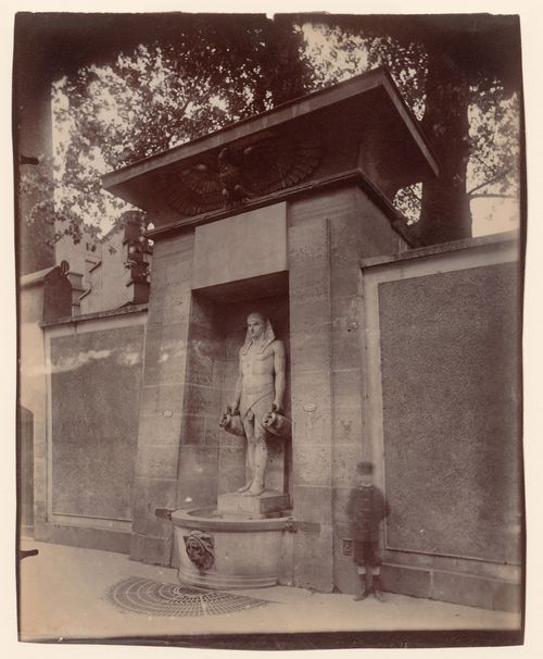 Egyptian style fountain, rue de Sèvres, with "ghost" of boy, Paris, France