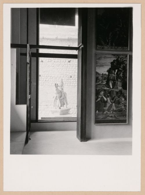 Interior view of a gallery showing paintings with the Can Grande della Scala Statue in the background, Museo di Castelvecchio, Verona, Italy