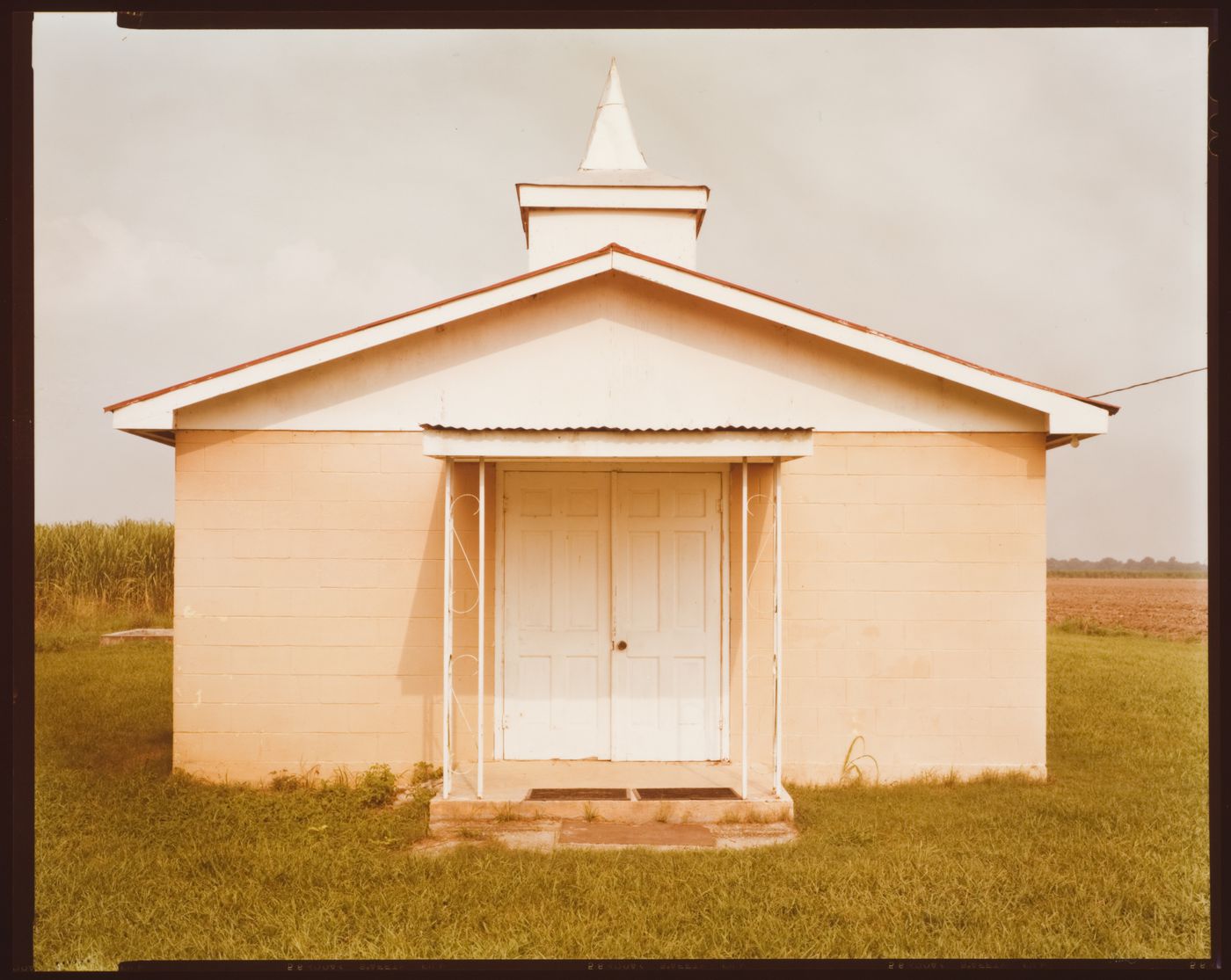 Cement block church in a cornfield. Napoleonville, Louisiana
