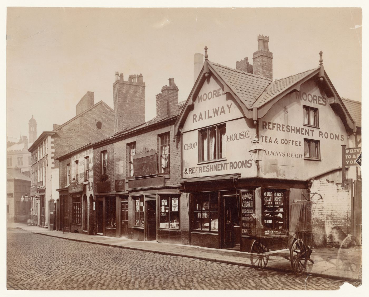View of shops in Long Millgate, including Moore's Railway Refreshment Rooms, Manchester, England