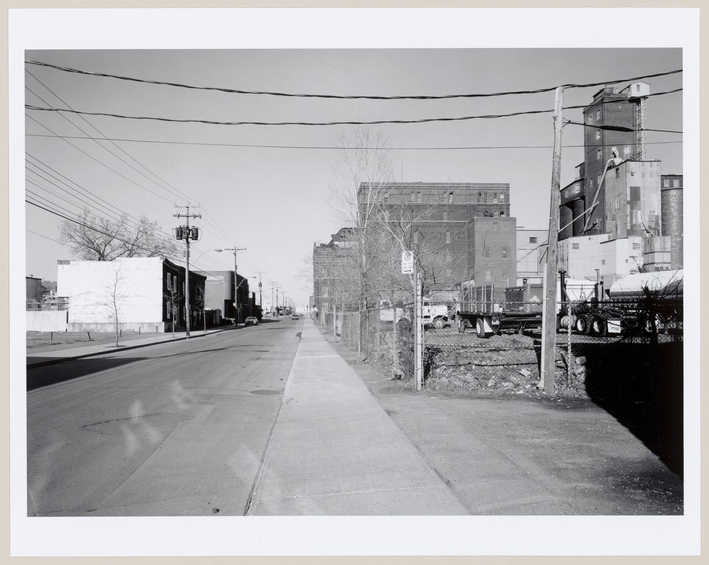 View of St. Ambroise Street between côte St. Paul and St. Rémi Street showing residential buildings on the left and the Stanchem Company Building on the right, Montréal, Québec