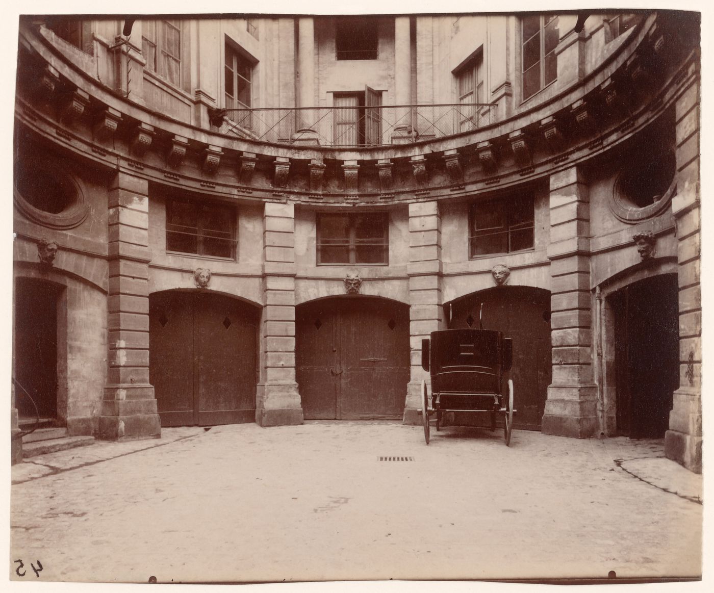 Hôtel de Beauvais: Back of courtyard showing garage doors and automobile, Paris, France