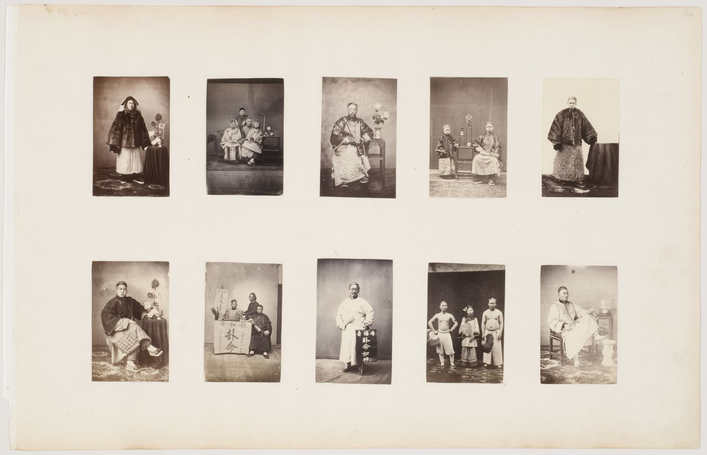 Portrait of a Chinese man seated beside a stand with one foot on a footrest