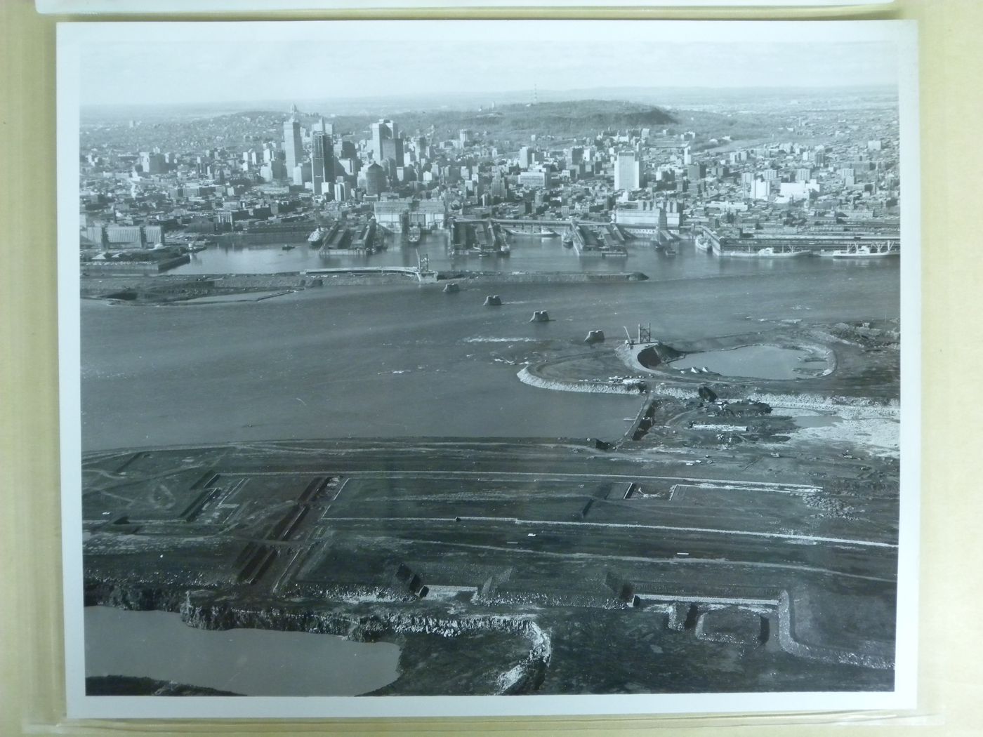 Aerial view of Montreal and of the construction site at an early stage, Expo 67, Montréal, Québec
