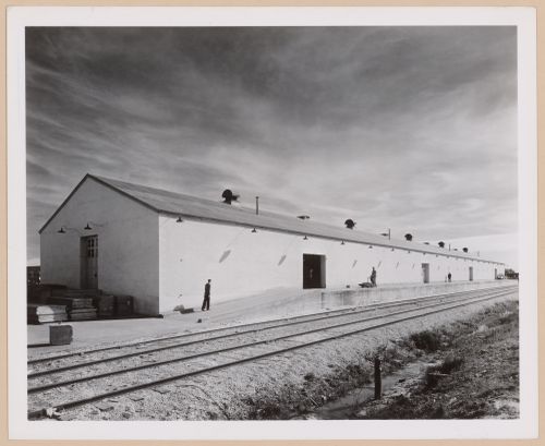 View of the principal and lateral façades of a warehouse showing the loading dock and train tracks, Consolidated Aircraft Corporation Assembly Plant, New Orleans, Louisiana