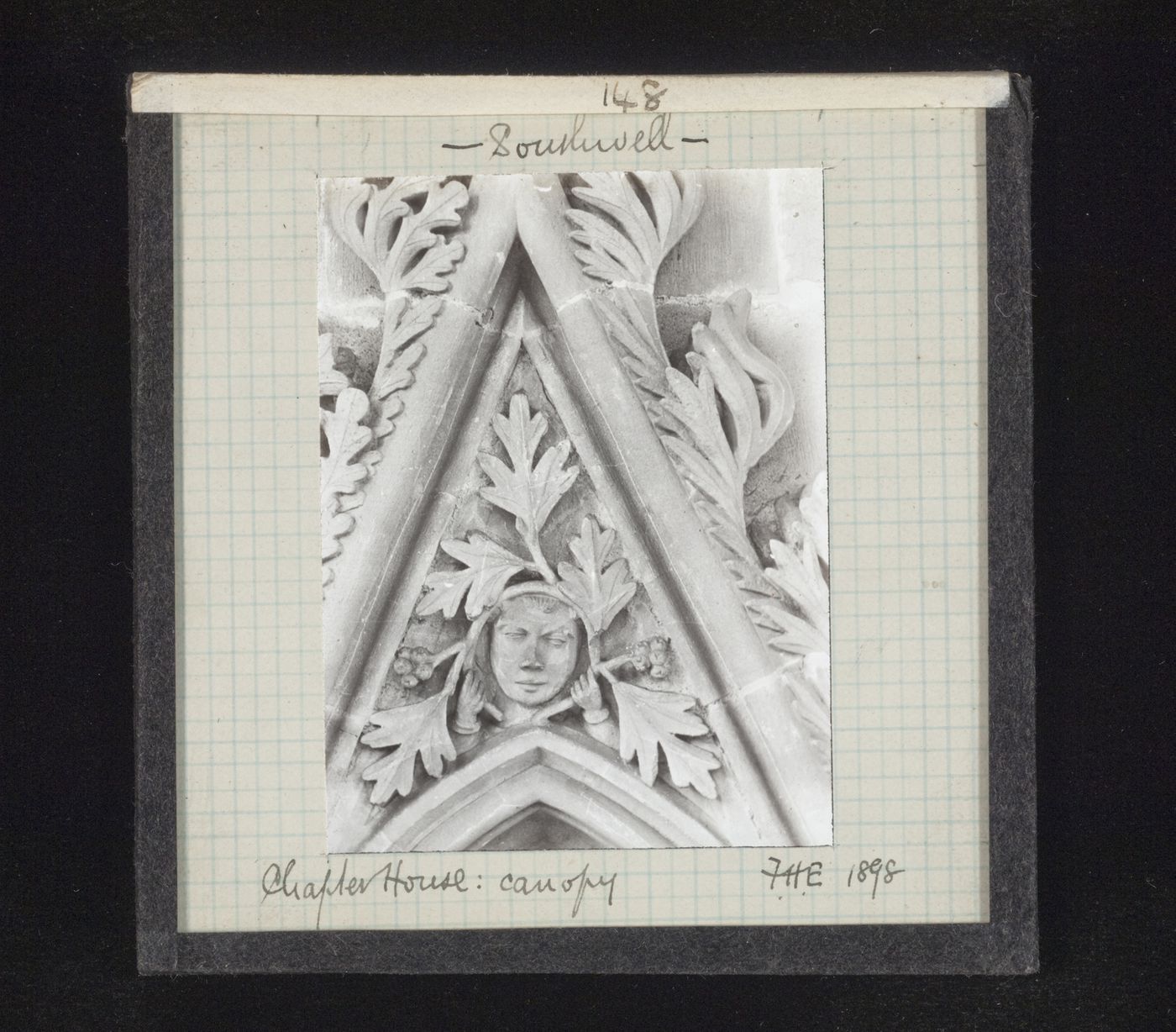 View of canopy with foliate mask on tympanum in Chapter House, Southwell Minster, Southwell, Nottinghamshire, England