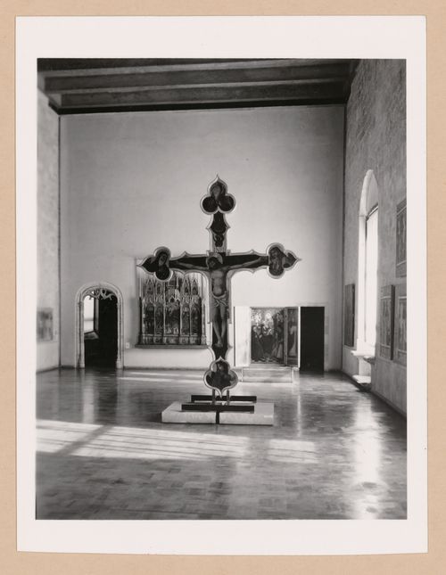 Interior view of a gallery showing a freestanding painted crucifix and paintings, Palazzo Abatellis, Galleria regionale della Sicilia, Palermo, Italy
