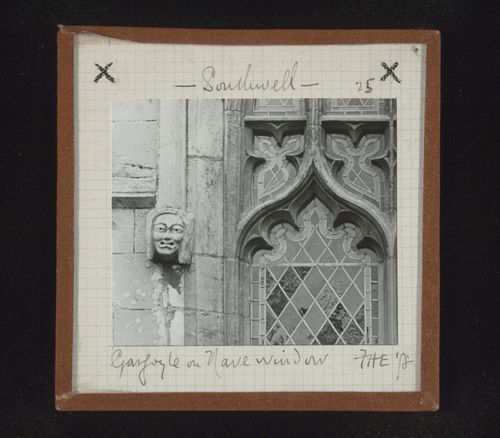 View of sculpture of head and partial view of stained glass window of nave, Southwell Minster, Southwell, Nottinghamshire, England